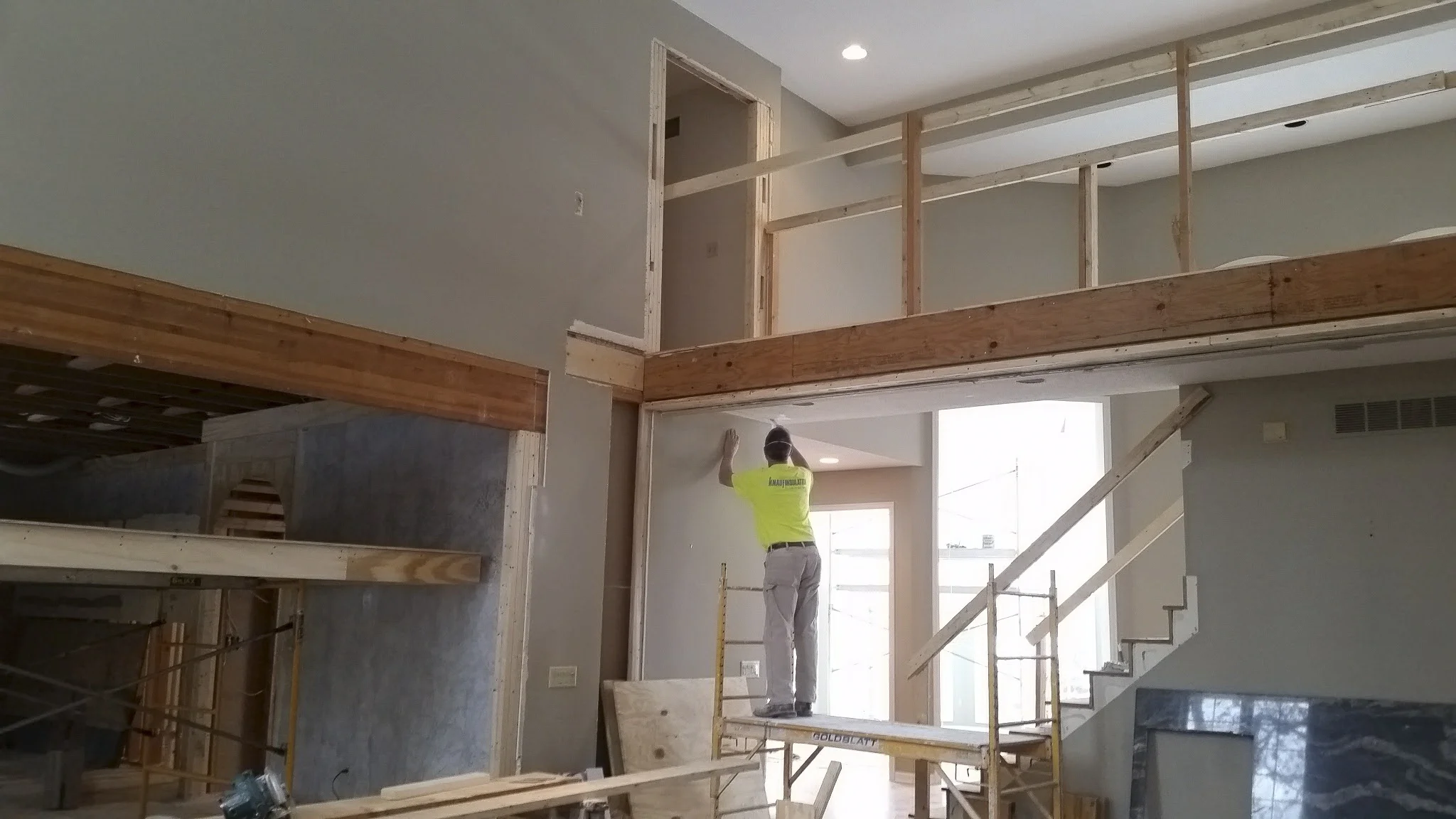 2nd floor balcony awaiting new flooring and railing. Hudick Drywall scraping and coating popcorn ceilings. Header between the great room and kitchen raised to open the space. 