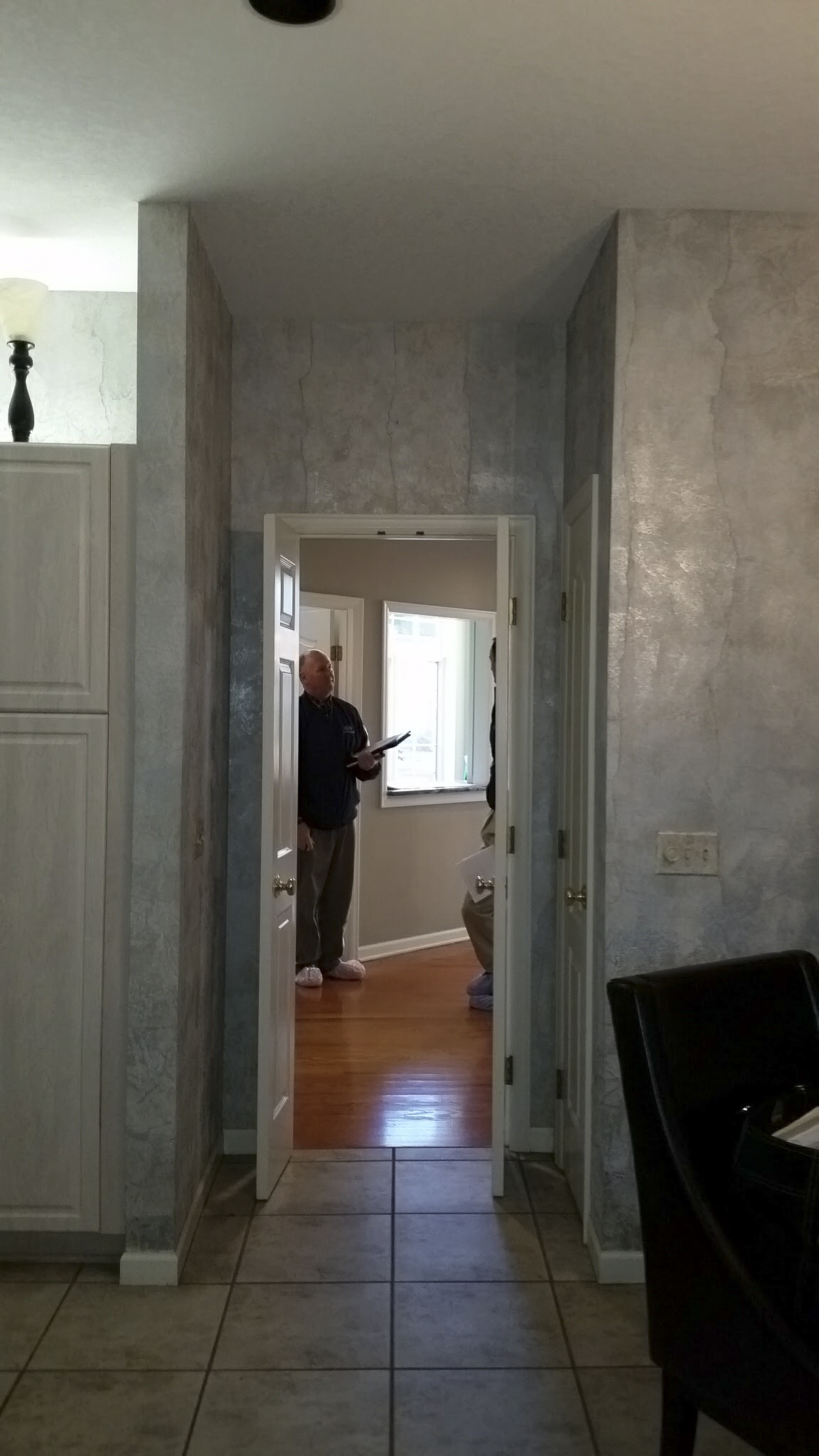 Cased open between mudroom and kitchen. To be converted to a paneled and cased arched opening featuring a hidden pantry drawer.