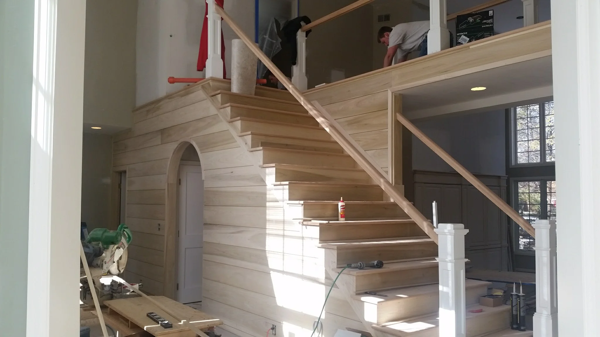 Shiplap foyer and stairwell walls with open-tread stairway sanded and fitted.