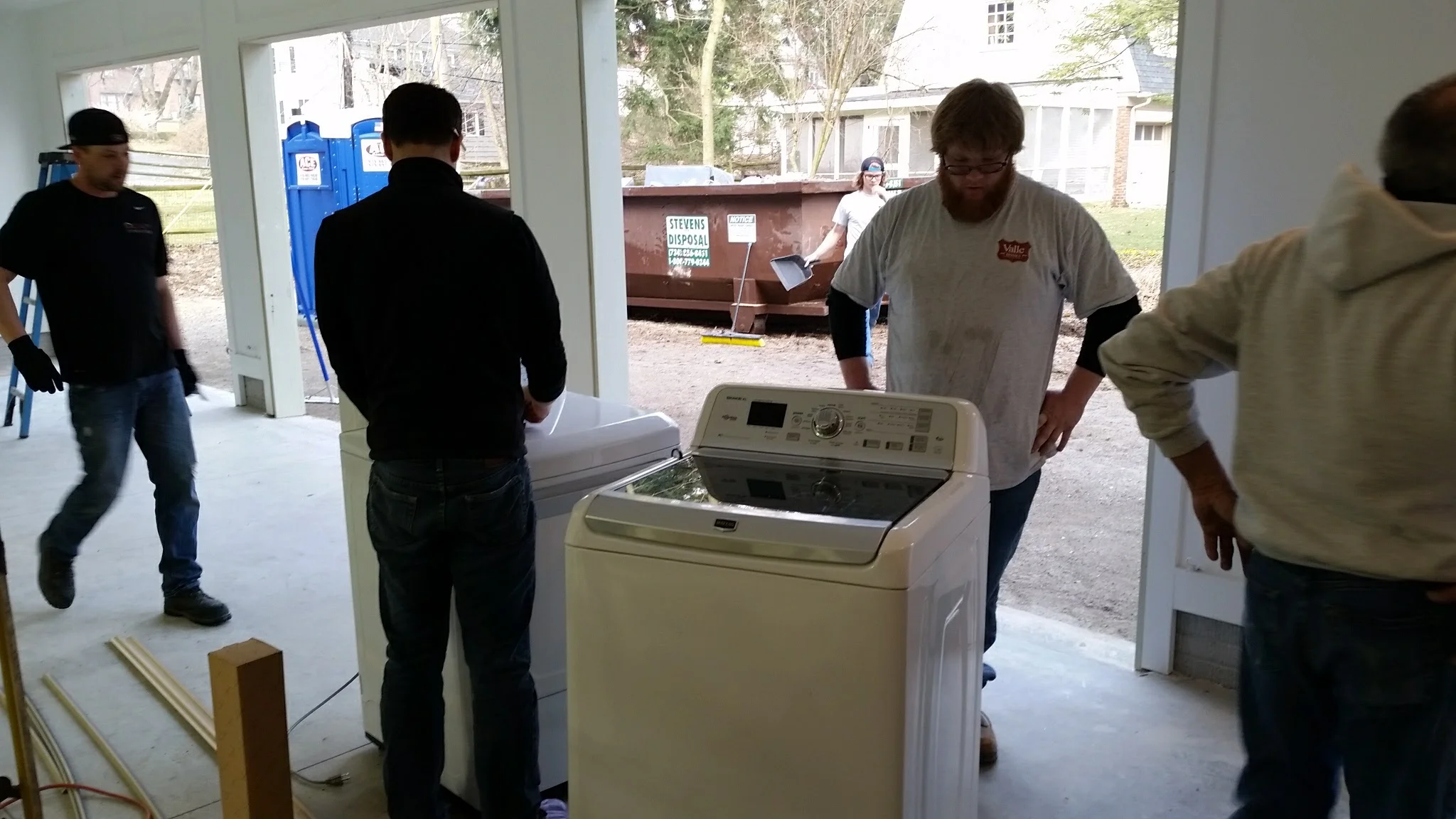 Moving appliances into upstairs laundry.