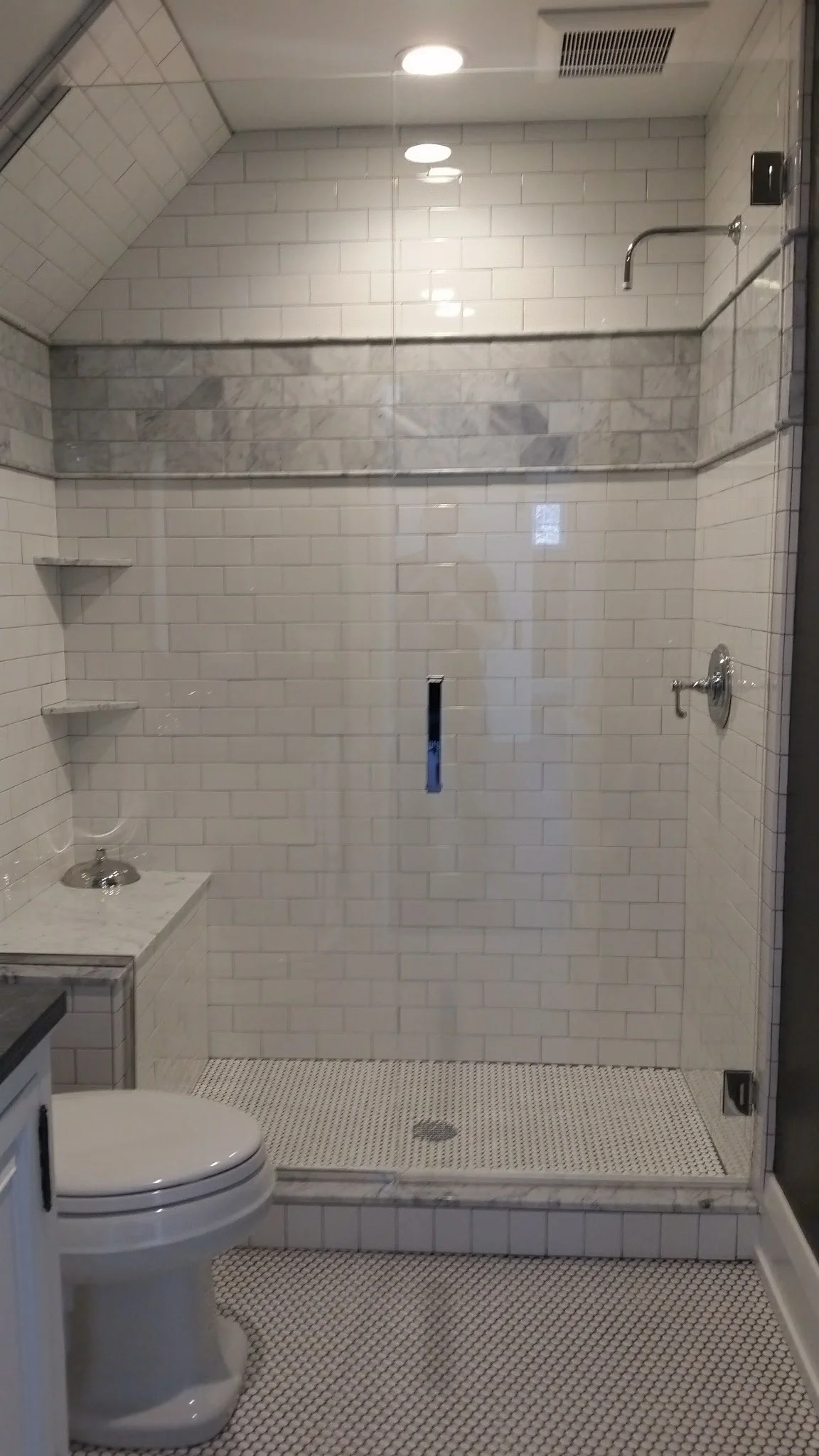 Full tile shower w/ bench and Euro glass door.