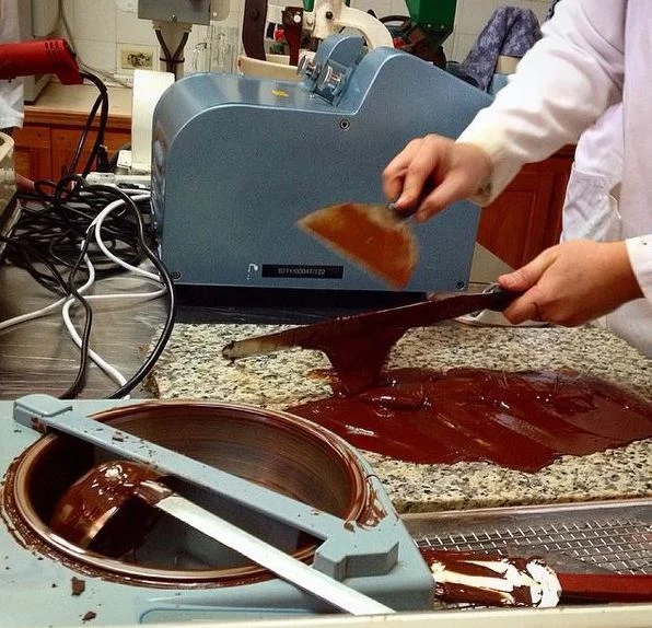 Learning to temper chocolate at the Cocoa Research Centre in Trinidad. Image credit Simran Sethi