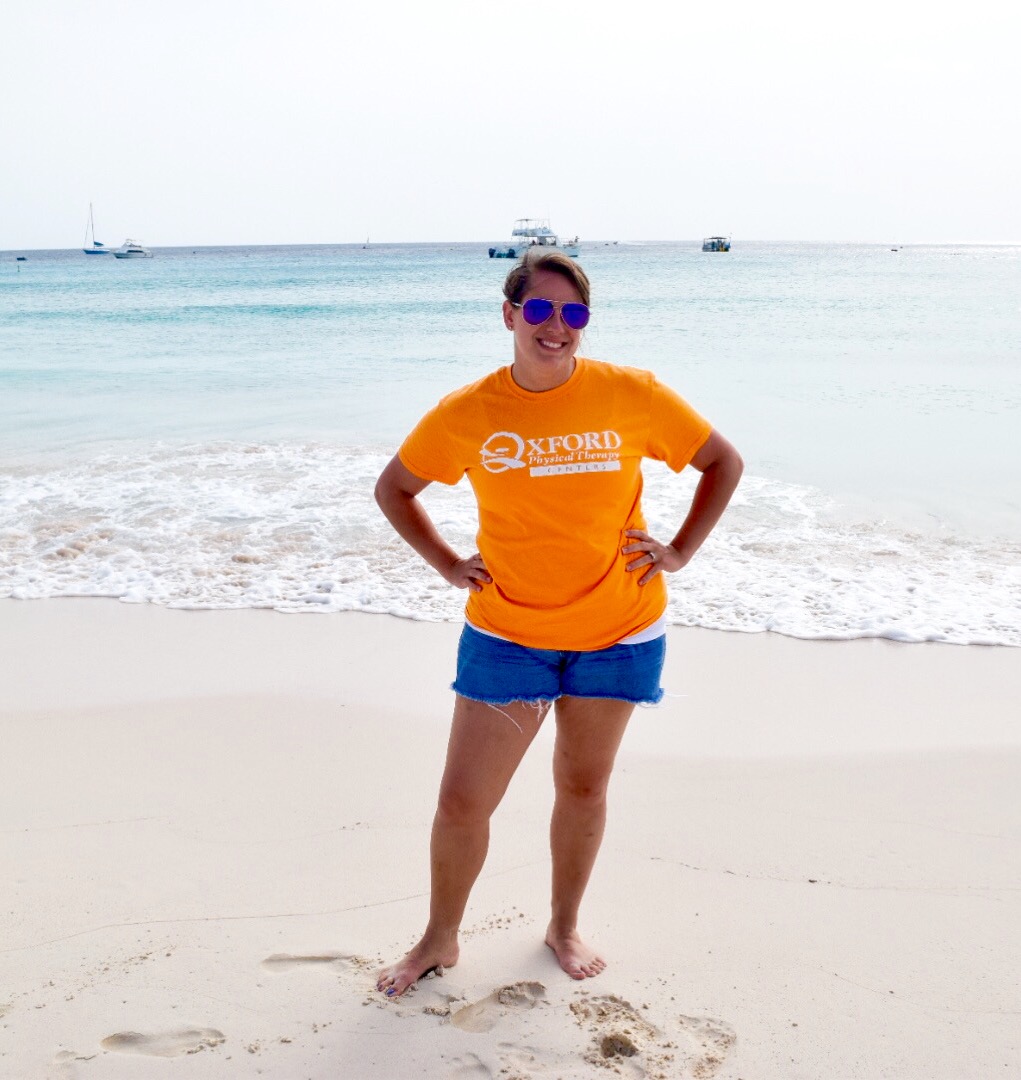 Liz H on the beach in OPTC shirt.JPG