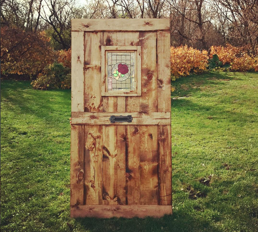 Barn door with rose stained glass window