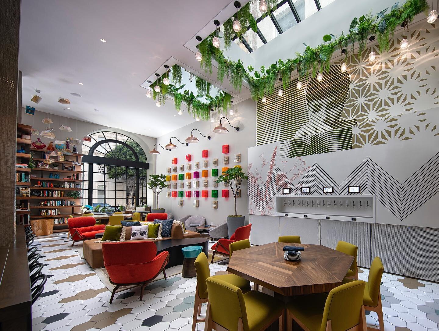 This funky lobby offers comfy seats, a chance to pour your own beer, and bright natural light from the huge skylight above. Swipe to see the messy construction phase that came first.

Photography: @jimbartschphotographer