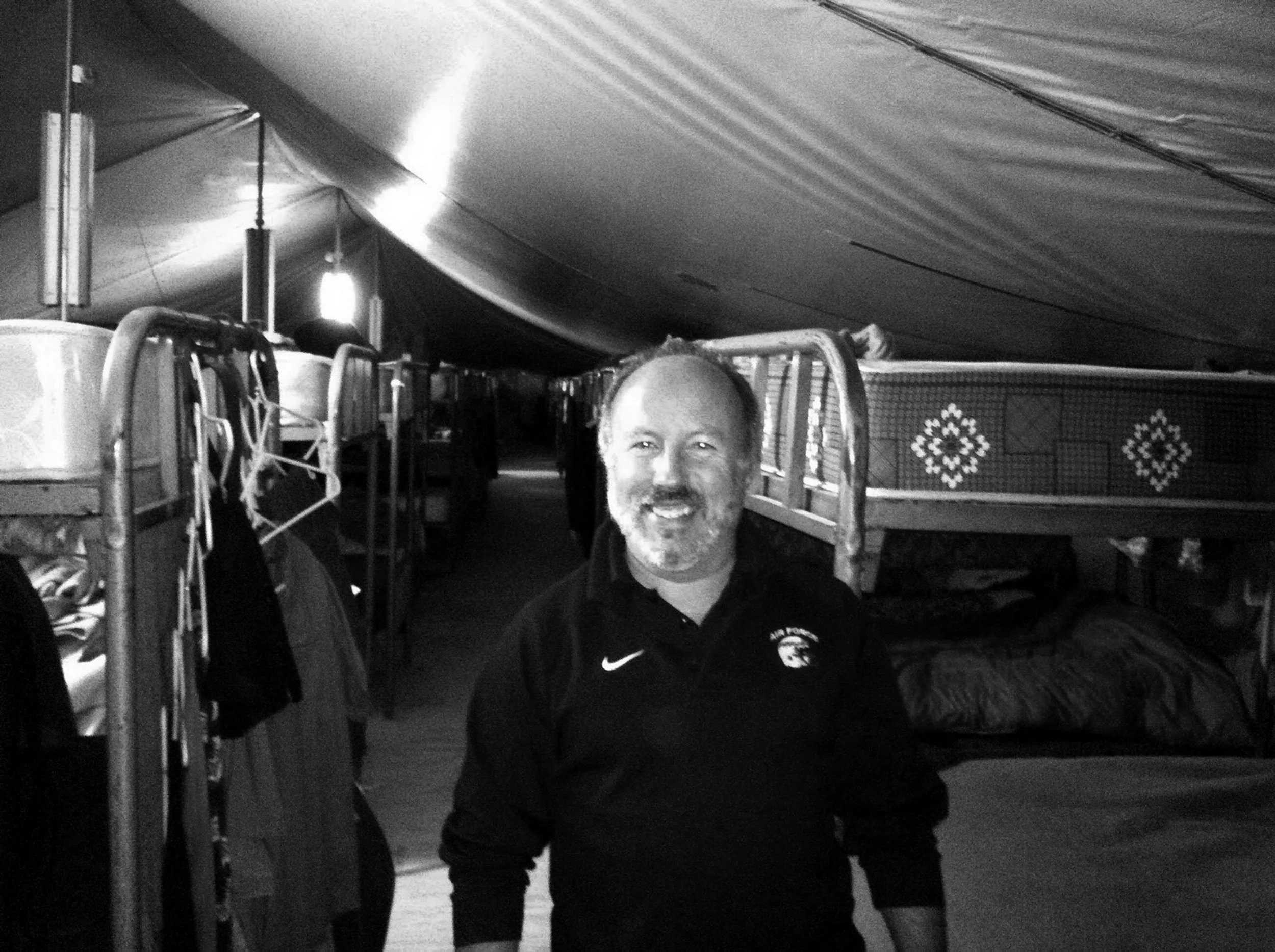 Davis standing inside his tent, directly in front of his bunk.
