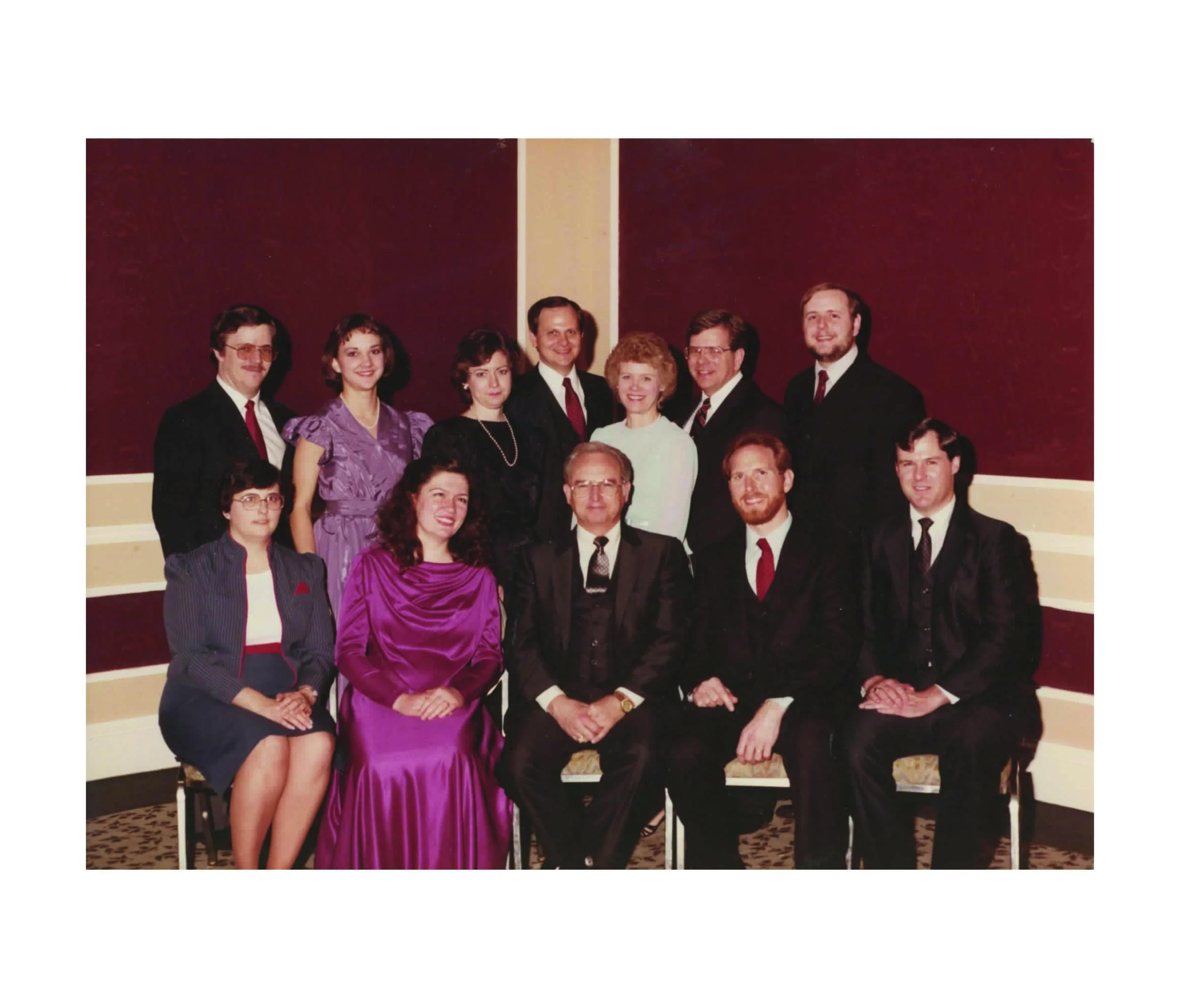 Founder Charles Simpson (sitting, center) and Beth (standing, second from the left)