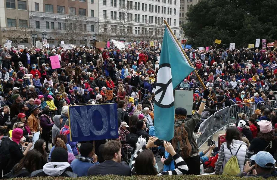Photo: Paul Chinn, The Chronicle - Thousands gather in Frank Ogawa Plaza for a rally held after the Women's March in Oakland. Local businesses applauded the daytime protest as the right way to do things in Oakland.