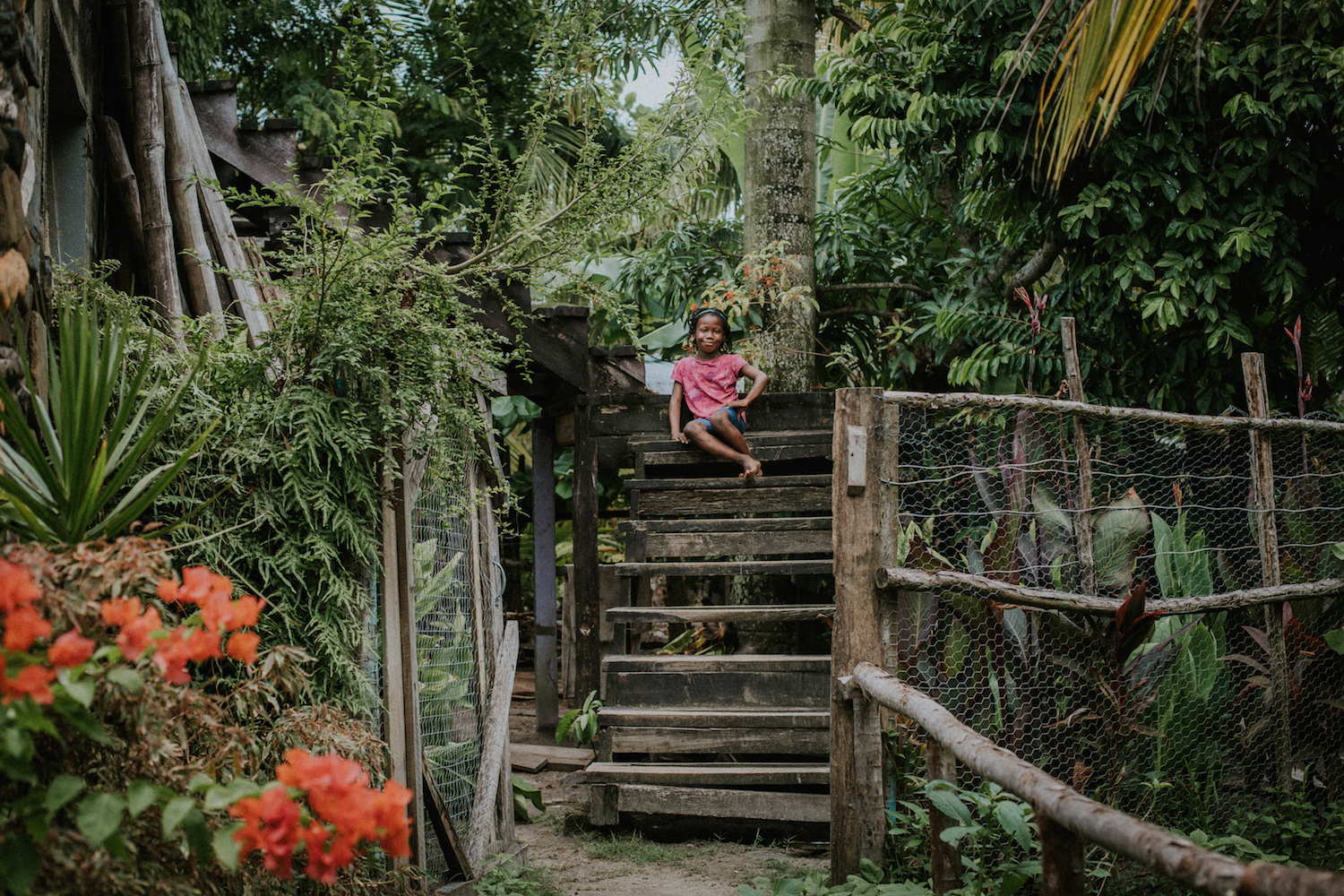 Josephine poses for a photo on her grandmother's front porch steps in Gales Point, Belize. 