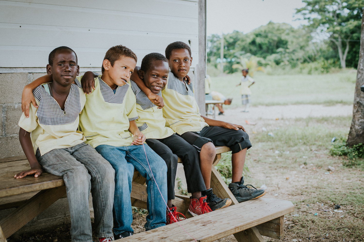  A group of young boys pose for a picture while on their lunch break. Some of the students choose to walk home and come back after they eat, but others like these guys, decide to stay and hang out with friends. 
