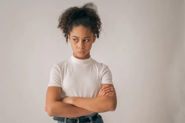 https://www.pexels.com/photo/anxious-black-girl-with-crossed-arms-7114724/