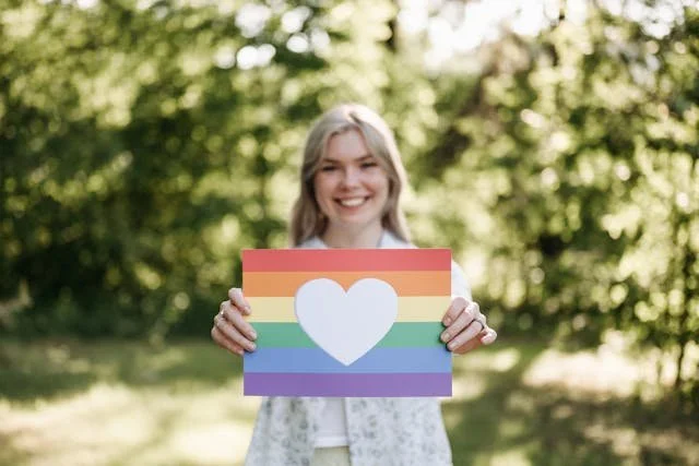 https://www.pexels.com/photo/woman-holding-rainbow-flag-8551910/