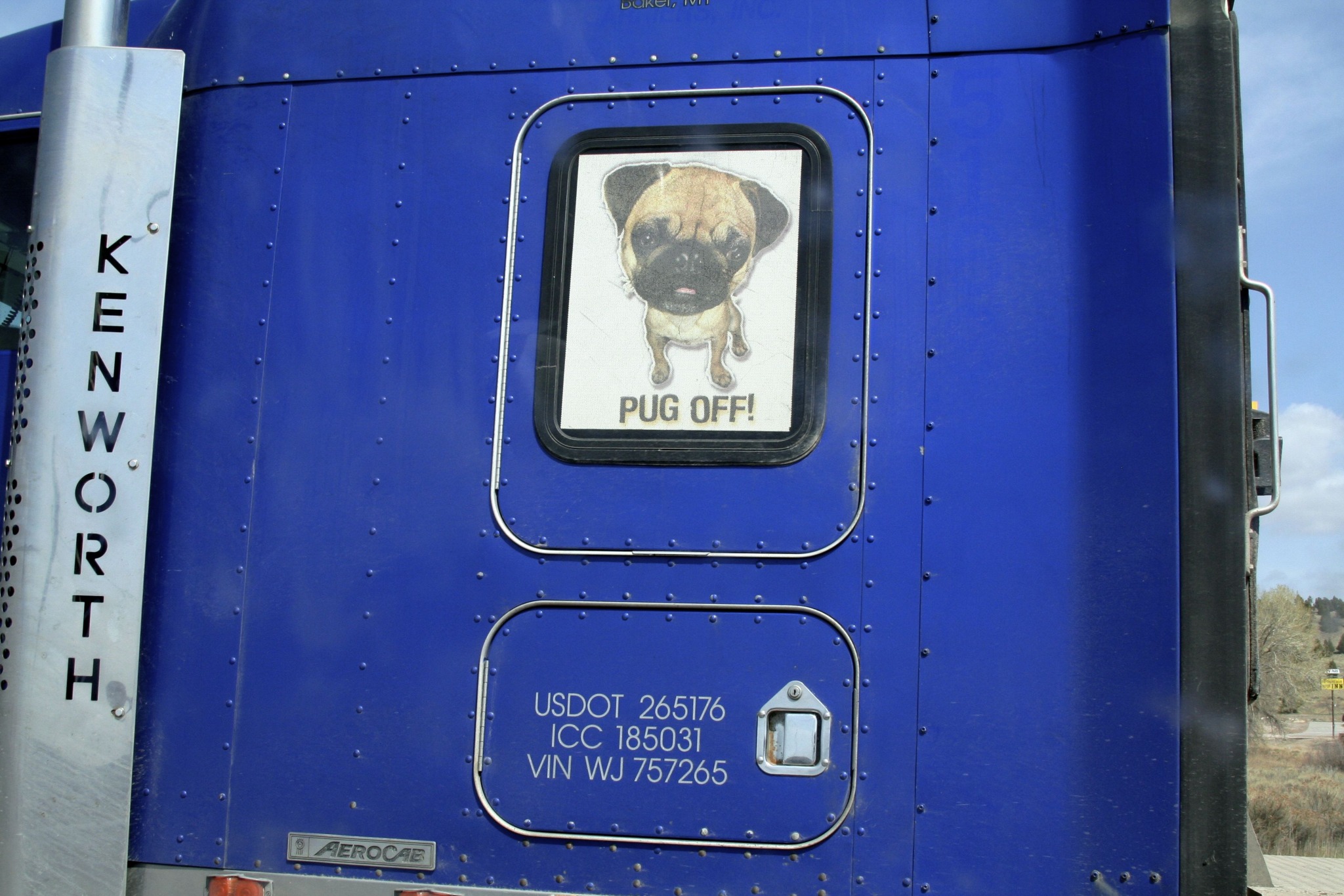 Bobbleheaded, pug-based threat on 18-wheeler's cab = pinnacle of manliness.