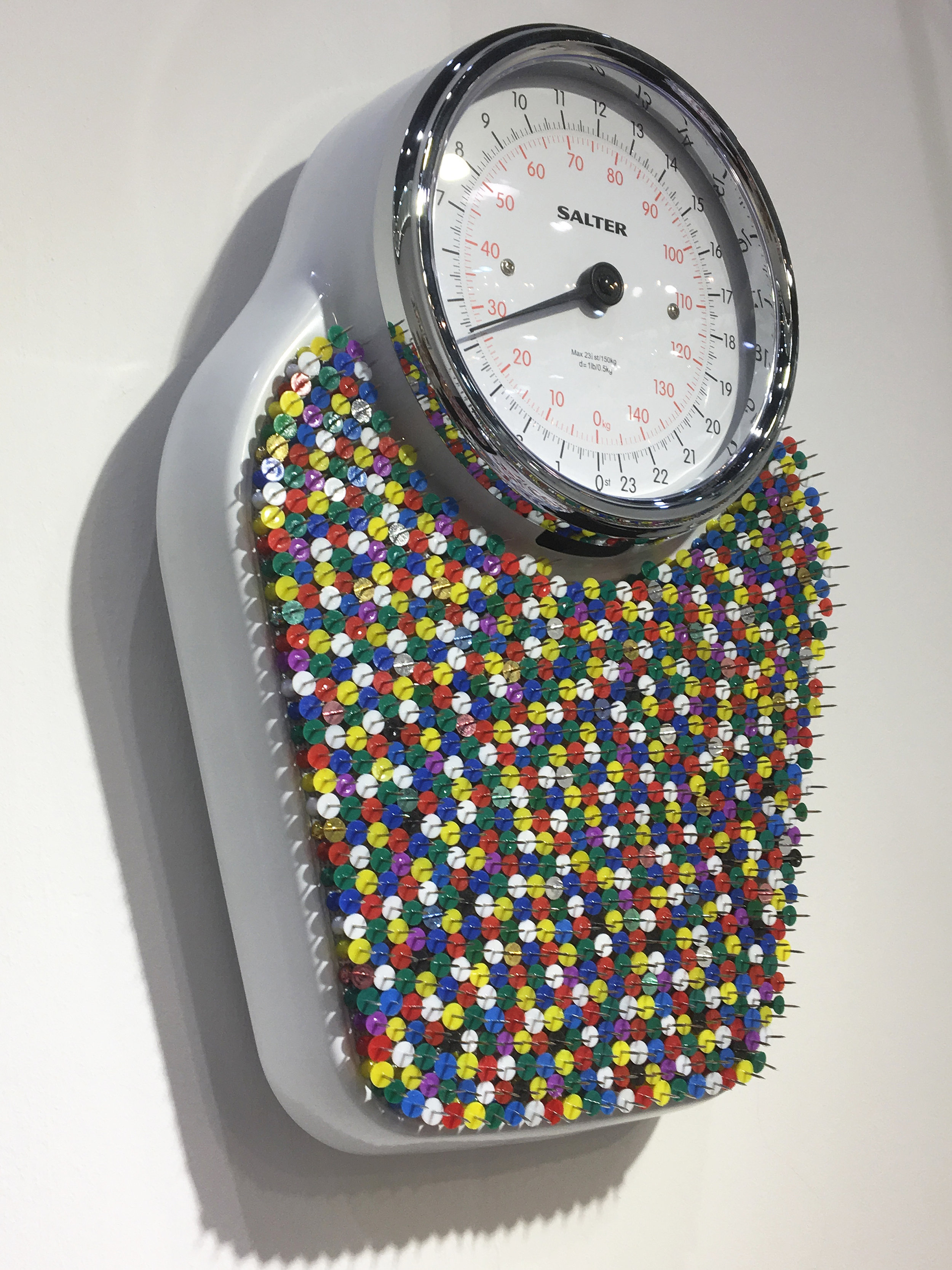 The scales have been hung on the wall above the bed, like a 21st century religious icon…