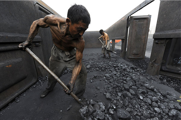 Trabalhadores descarregam carvão em um depósito ao longo da estação ferroviária de Hefei, na província de Anhui. Outobro de 2000.