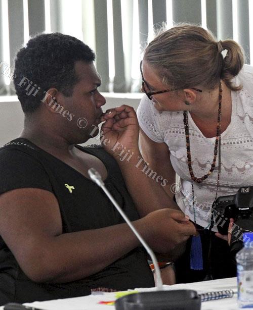 Amasai Jeke, left, of the Haus of Khameleon with Ellie van Baaren (UN Women rep) at the Violence Against Women training workshop in Suva yesterday. Picture: ELIKI NUKUTABU