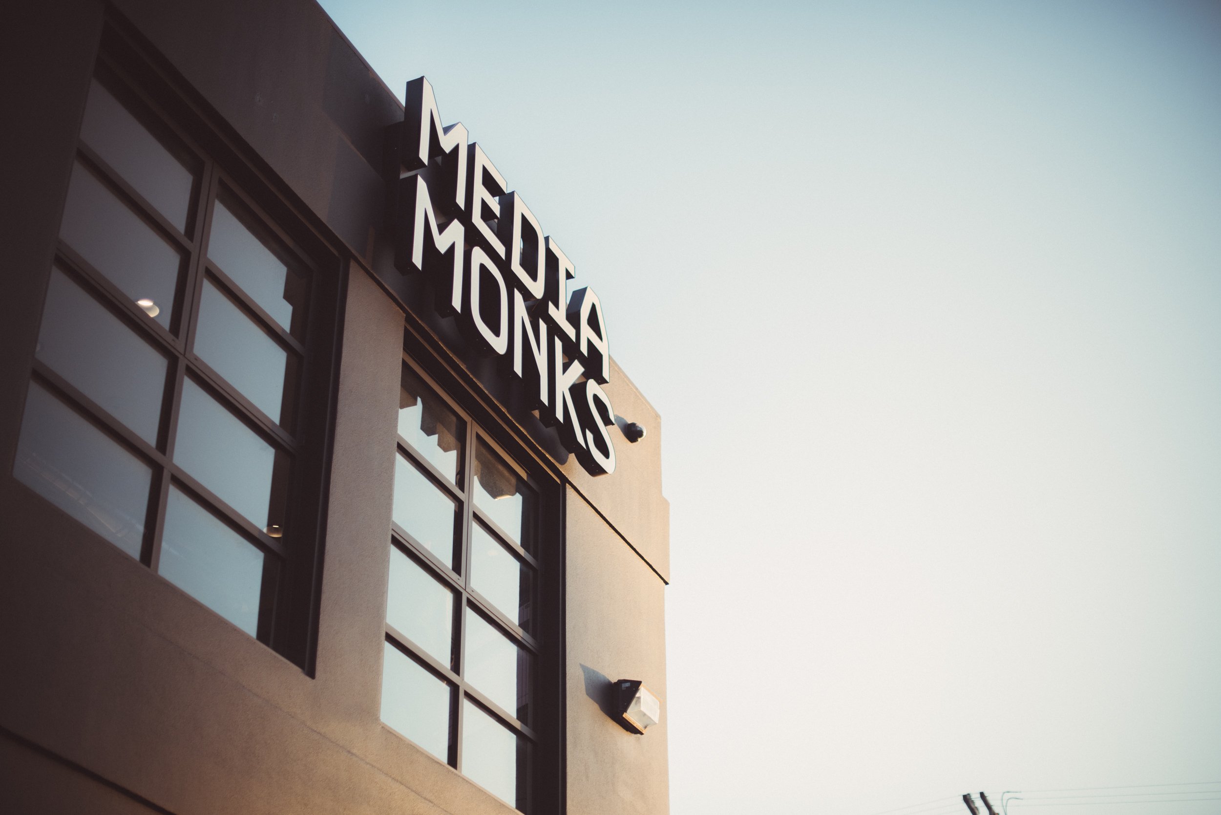 Exterior of a building with 'Media Monks' sign."}