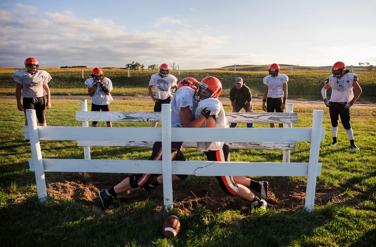 To practice agility and balance, coach Landon Miller has players go head-to-head until one player pushes the other out of the fenced-in chute. The fences are placed no more than 3 feet apart, and each fence is about 10 feet long.