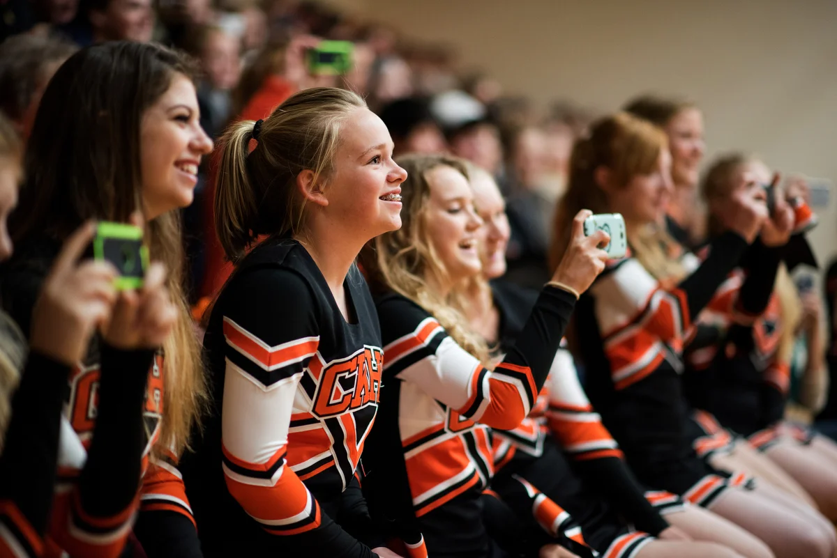 Cheerleaders Lesli Schneider, Tati Jones and Julia Habsburg watch the football players' skits from the stands during the pep rally.