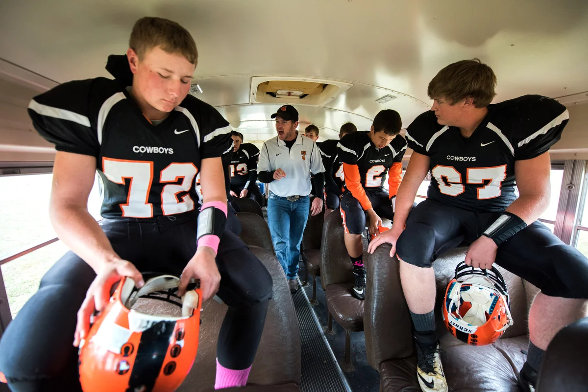 The team takes a bus from the high school to the football field across town. The trip is less than a mile, but Miller uses the time to give a short pep talk before games.