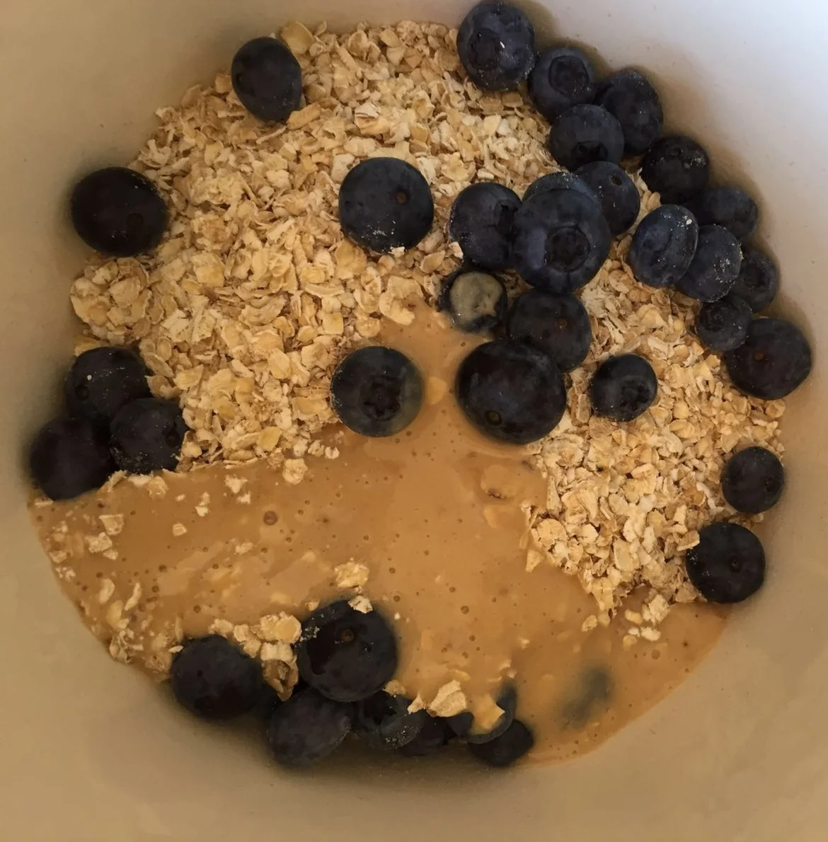 Adding the dry ingredients to the blended banana, milk, cashew butter & maple syrup
