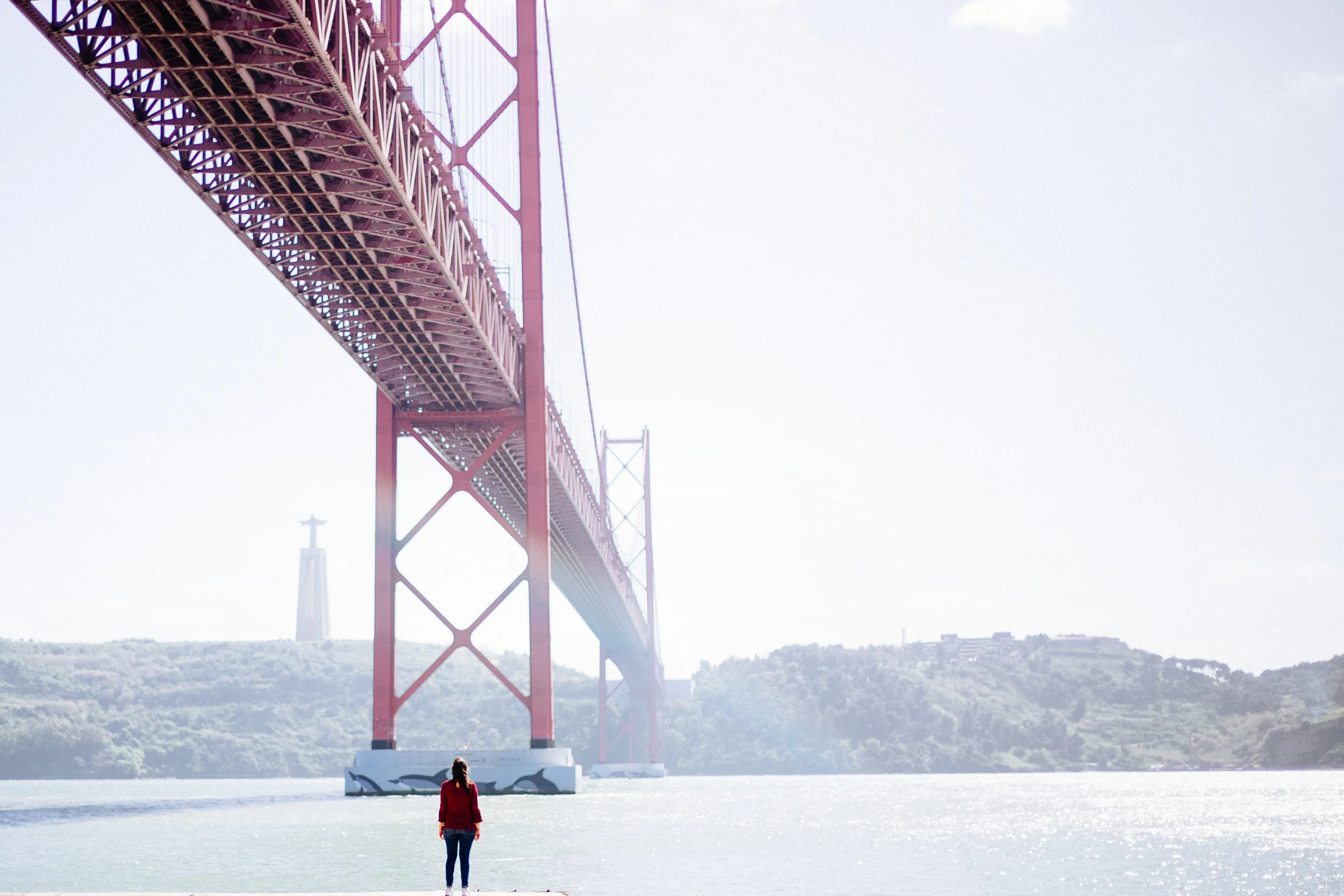 25 de Abril bridge and the Sanctuary of Christ the King looking over the city of Lisbon
