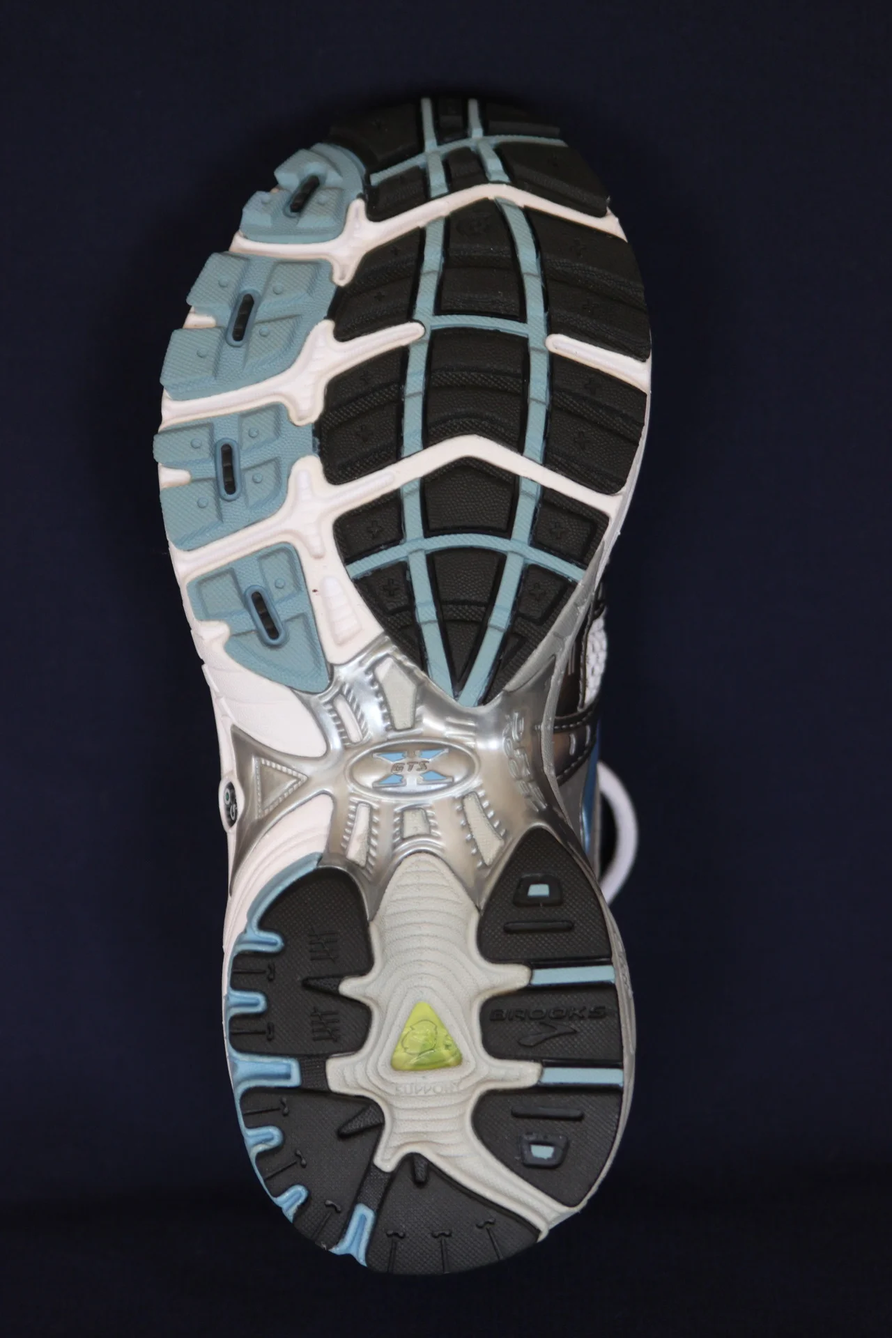 Shoe Facts : The Outsole (also called the “sole”)
This is the part of the shoe that comes in contact with the ground. It is often made of rubber and provides for traction and some degree of shock absorption. It can be sewn, cemented or integrated with the midsole.
Remember that the heel strikes the ground at approximately a 16 ° angle, lateral from the center of the heel. The force is then transmitted from the sole of the shoe, up the lateral column of the foot and across to the first metatarsal for propulsion (add link see mondays post here for more on progressional forces ). This can be assisted by a “rocker” which is a “drop” put into the front portion of a shoe, to ease walking and assist in toe off (more on this in another post).
A flare to the sole of the shoe (usually at the rear, medial or lateral), can be important for stability on uneven surfaces, by providing a bigger “footprint” or surface area contacting the ground (much like Dr Allen’s new Dodge truck). A lateral flare provides extra stability upon heel strike by preventing too much inversion of the heel, but it speeds up the rate of pronation . A medial flare would slow pronation (not great for a supinator though, or folks who keep weight on the outside of the foot for extended periods of time). This flare’s placement (whether medial or lateral) will profoundly affect forces at the mid tarsal joint as the foot comes through mid stance.
The Gait Guys. Making you more “shoeliterate” each day!
Want to know more? Email us at thegaitguys@gmail.com for information about our National Shoe Fit Certification course.
copyright 2012 The Homunculus Group/ The Gait Guys. All rights reserved. DON’T RIP OFF OUR STUFF.