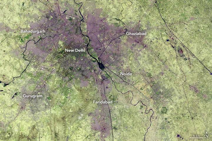 Croplands and grasslands around New Delhi are being converted into city structures to create one of the fastest urban expansions in the world. Credit: NASA Earth Observatory