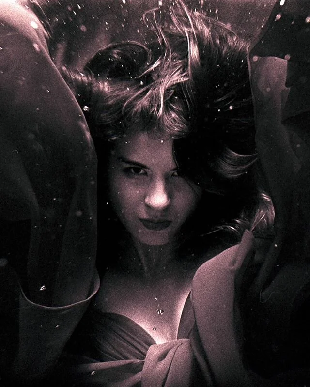 I love the intensity of this image. The gaze. The framing provided from the dress guides the eye to the subjects face. The odds that these elements all lined up spontaneously through this single roll are astronomical. At this point we were probably s