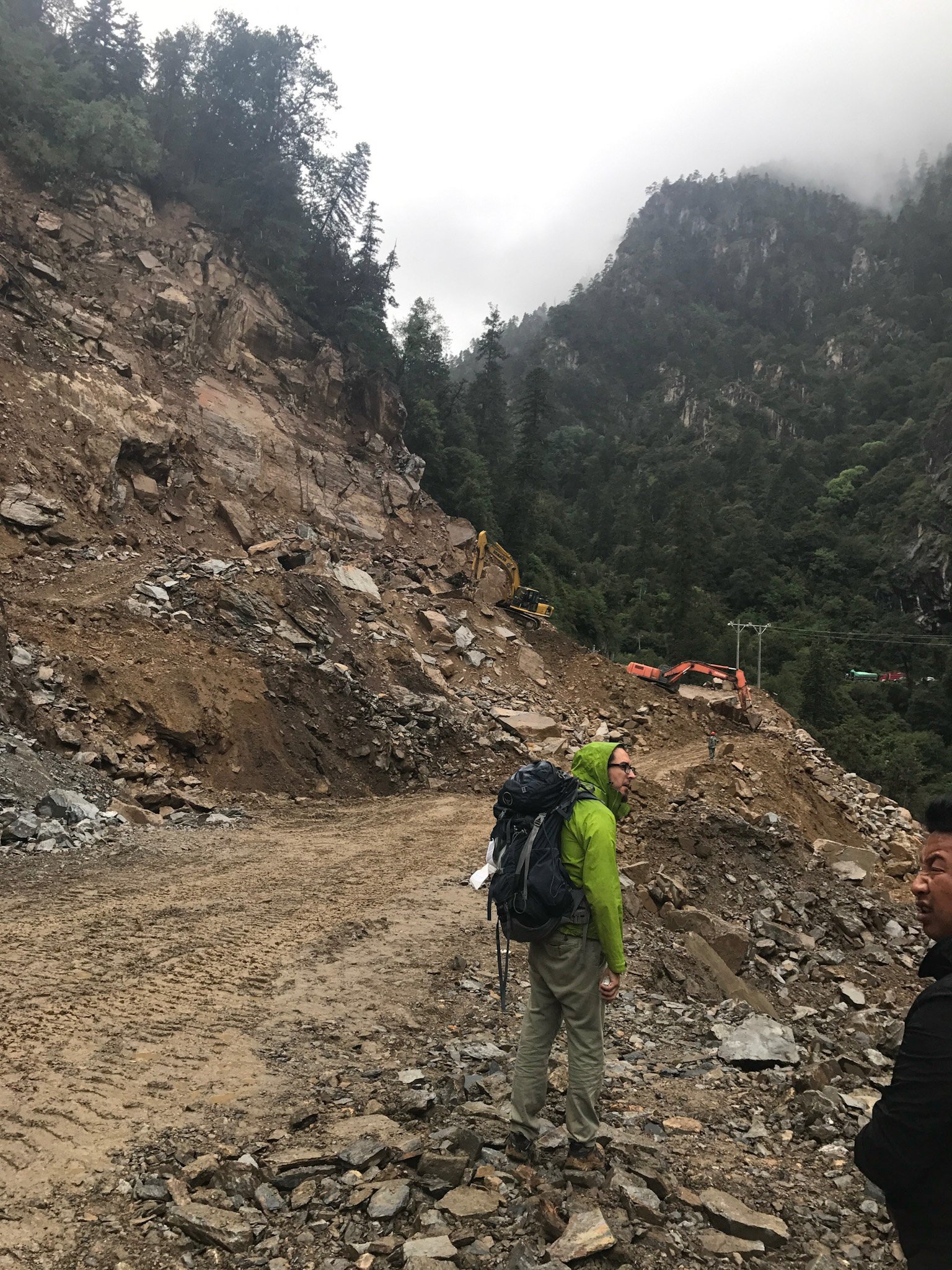 Roadslide crush excavator. Small hike to get to new car. Traveling to meet elder tibetan farmer.