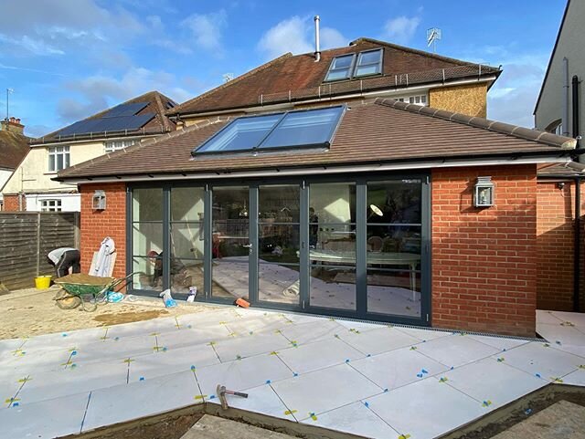 As we lay the porcelain patio tiles to a level threshold on this extension we built last year it really feels like spring is in the air. We are continuing to press on with all construction works as long as we can. Stay safe everyone. #construction #e