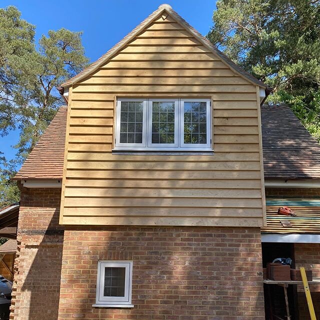 Green Oak feather edge cladding installed on this extension. It fits in with the leafy surroundings beautifully. #construction #extensions #renovation #carpentry #surreybuilders
