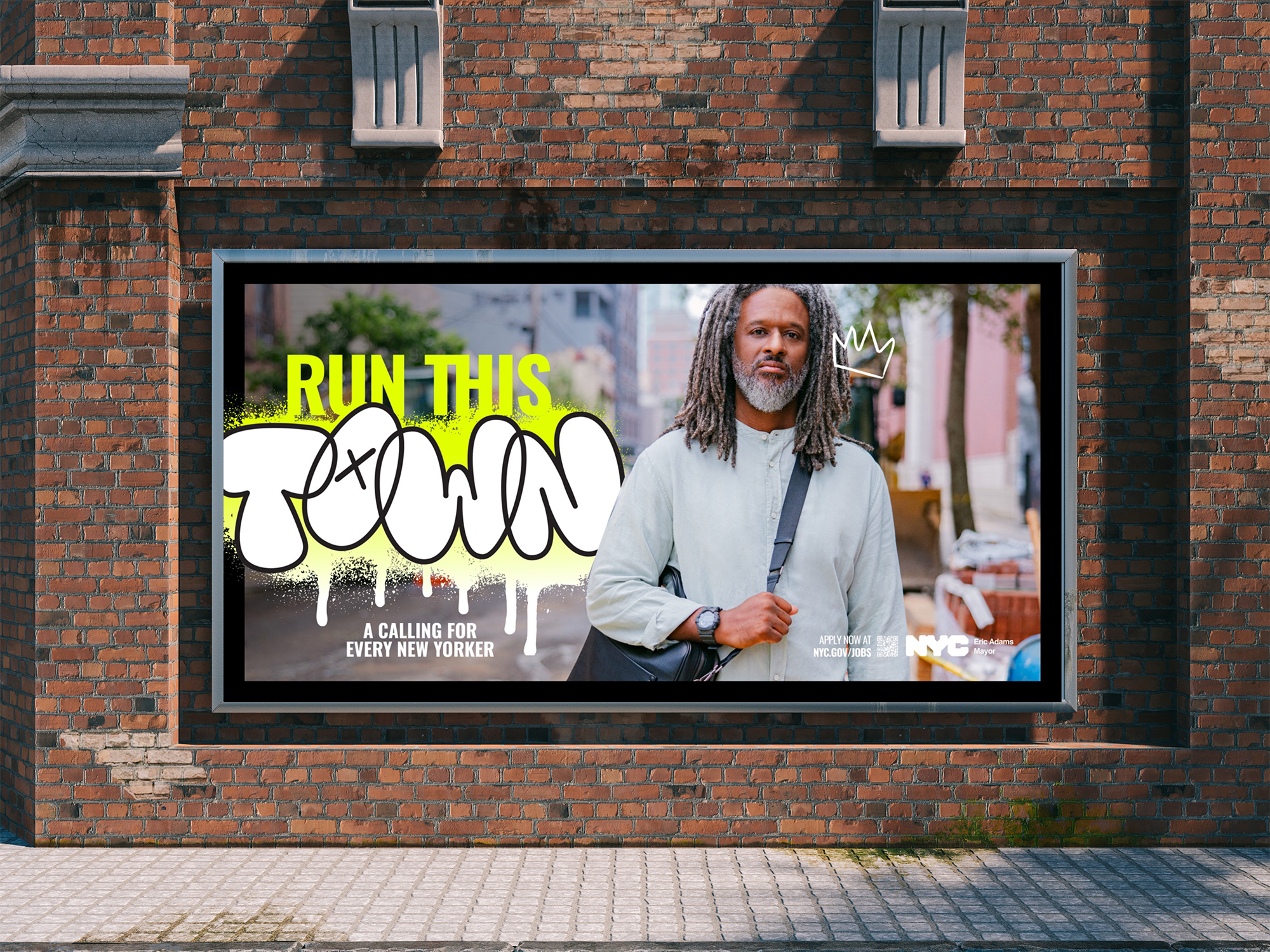 A billboard on a brick wall promoting a call for every New Yorker to run the town, featuring a portrait of a man with dreadlocks, wearing a light blouse and carrying a backpack, with graffiti-style text and a small crown drawing.