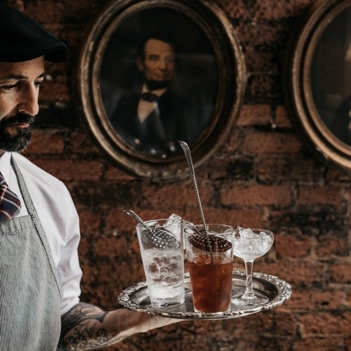 server carrying drink tray 