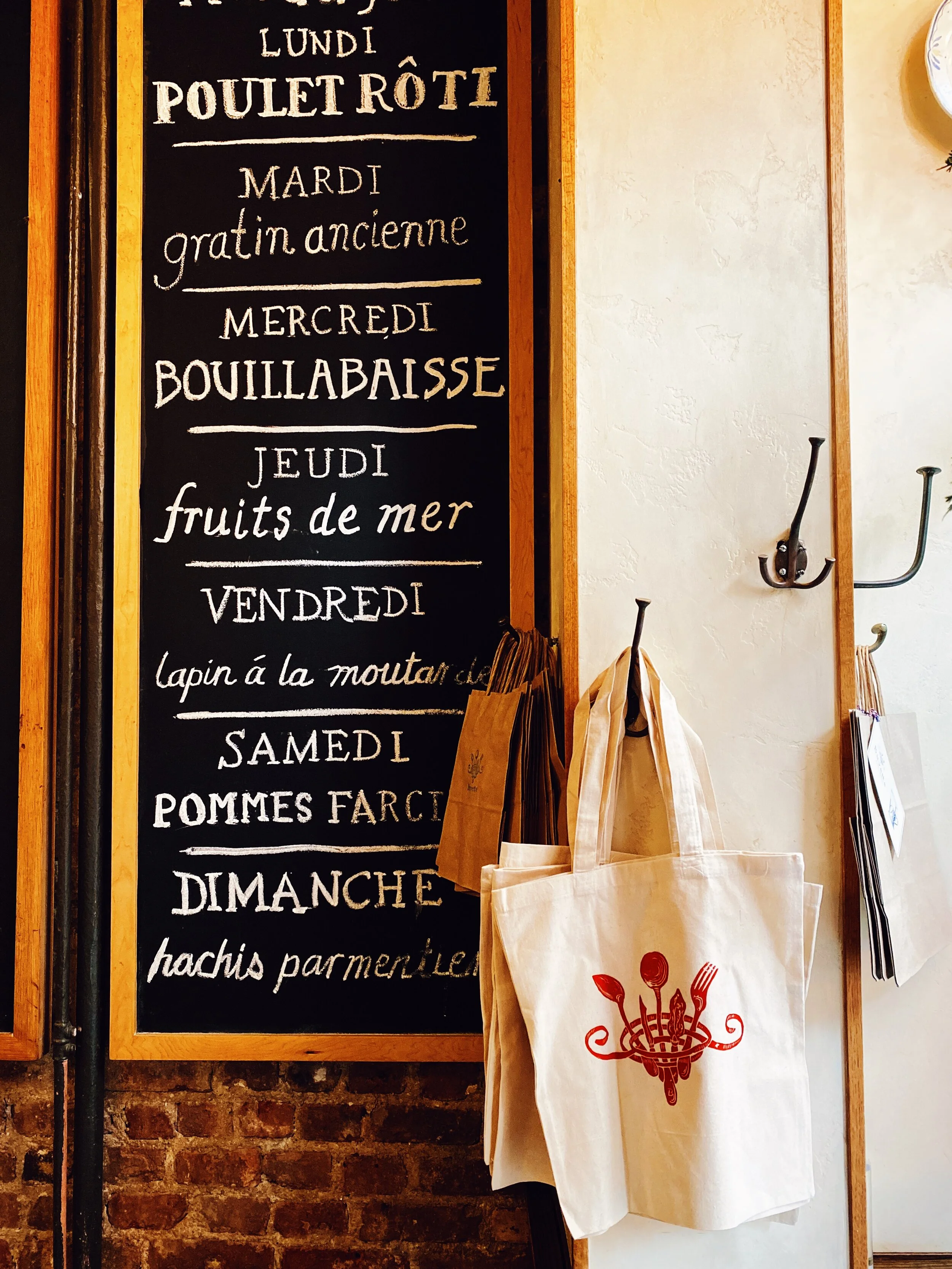 Buvette Tote Bag hanging on wall
