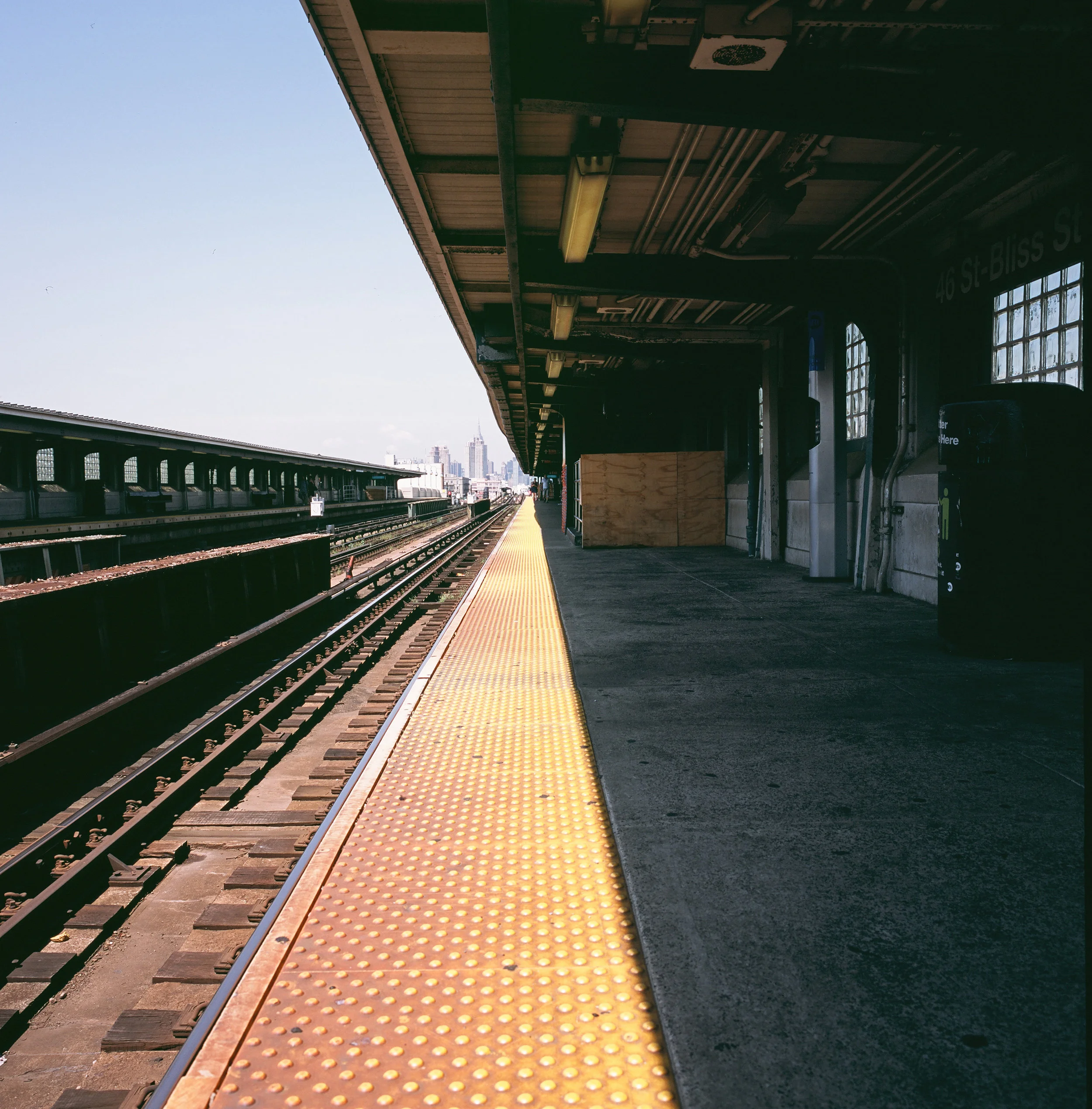  Slide film is frustrating but if I get one really good shot I’m happy!   You can almost feel the blistering heat on the platform edge and the (not really much cooler) sweet relief of the shade. Perfect timing for that shadow! This viewed on a light 