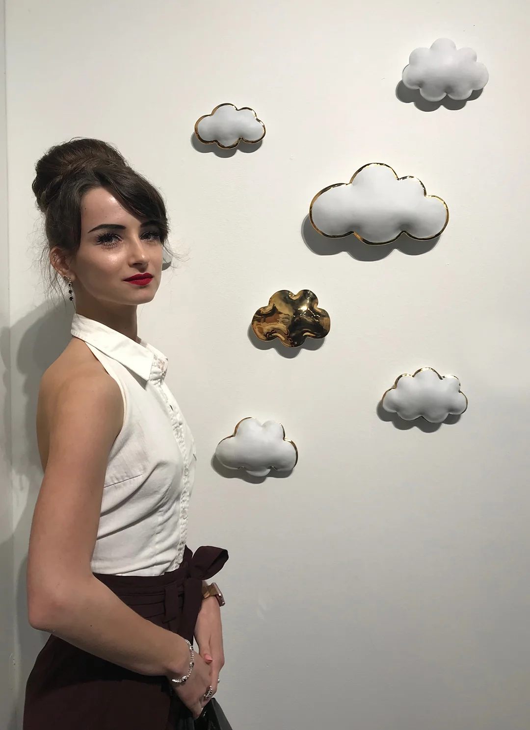  Czarina Ekaterine standing next to the porcelain clouds installation at Texas Contemporary art fair 