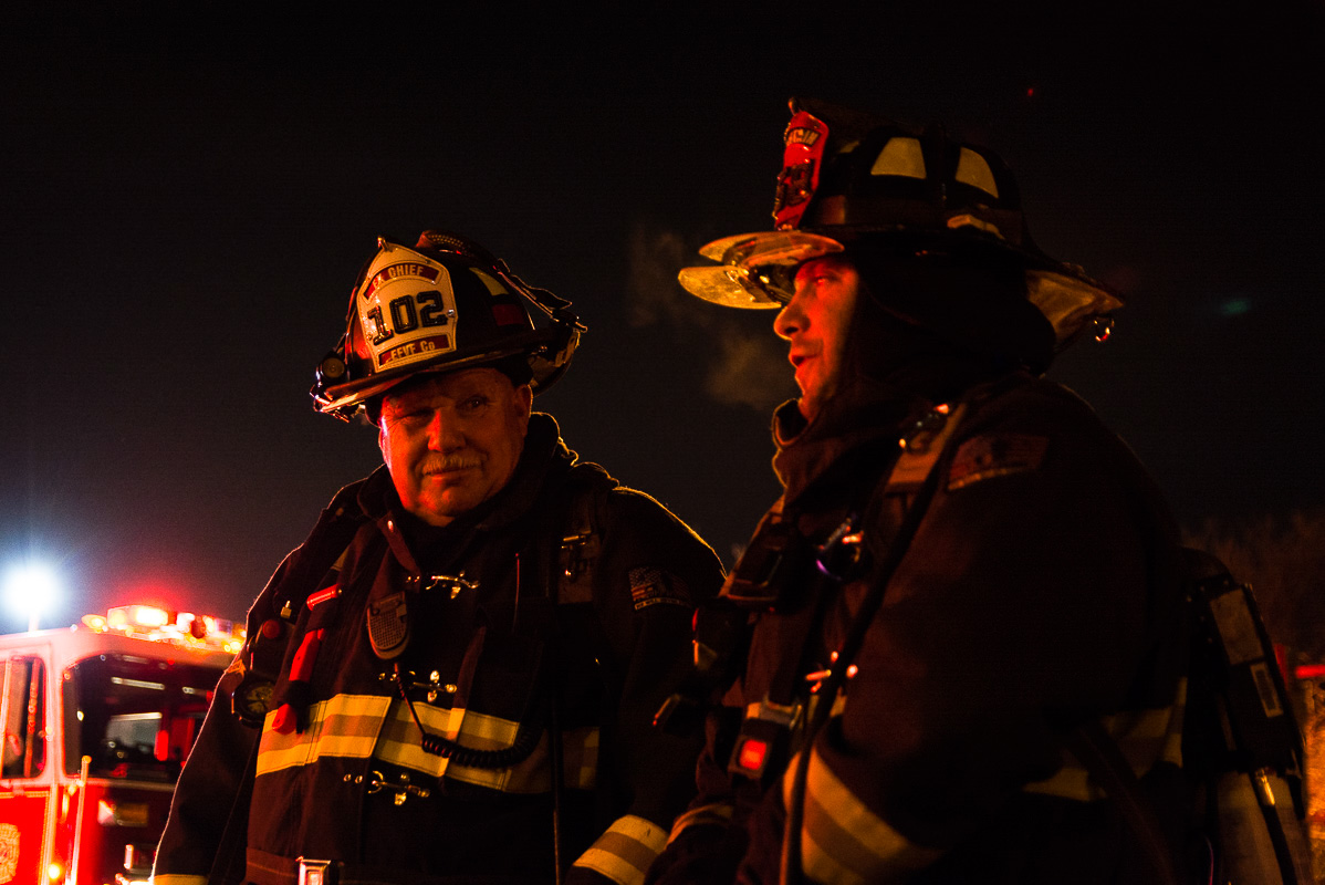 Former East Farmingdale Fire Company Chief Michael Kilbridge (Left) and former Captain Joseph Greco (Right) talk outside of a commercial building fire in North Lindenhurst on February 22, 2016.
