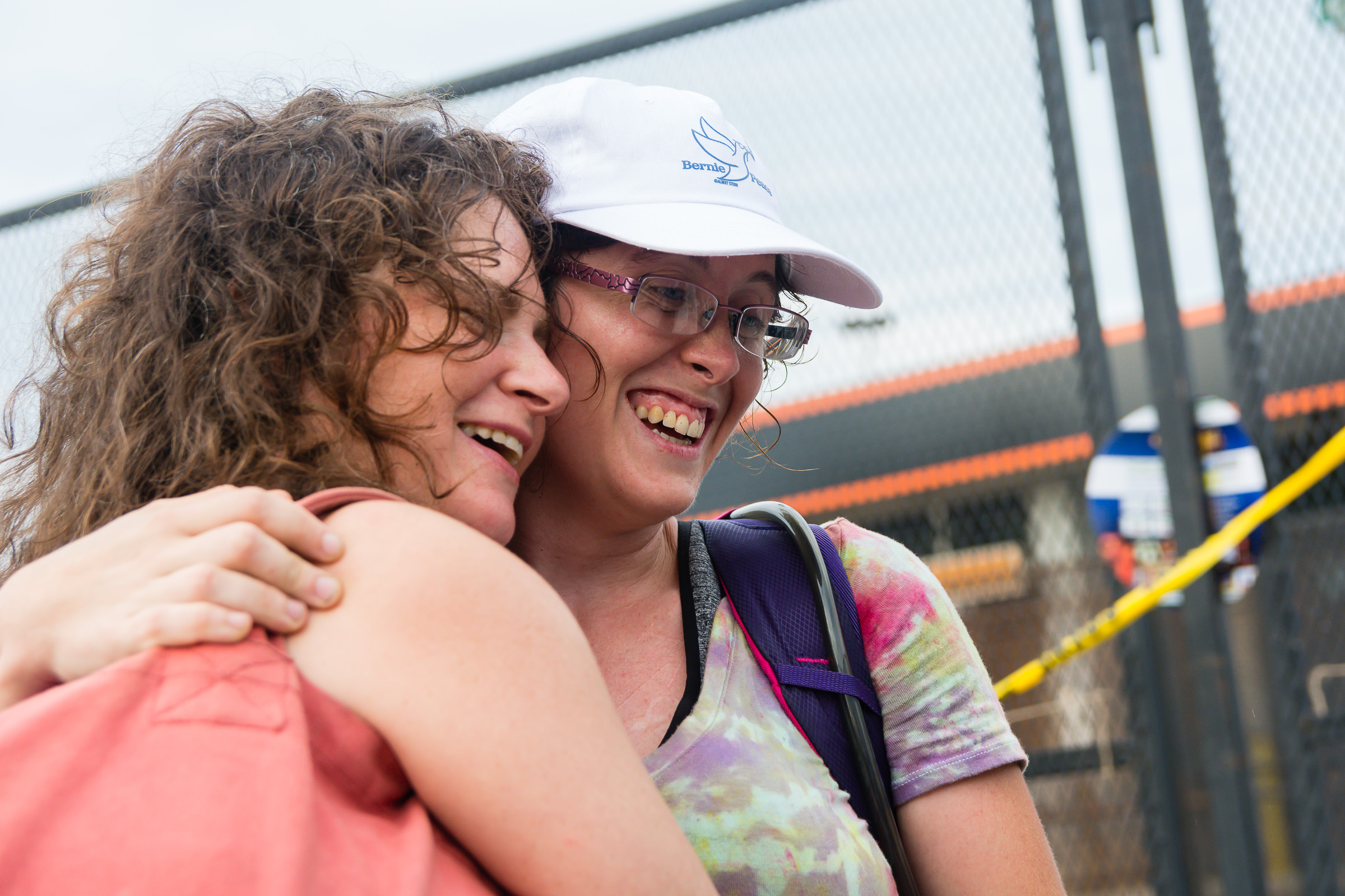 Gabrielle Engh, left, of New York City, and Coral Burriss, right, of Fredericksburg Maryland, embrace after meeting outside of the Wells Fargo center. Engh spent the night in FDR park with Occupy DNC. The two women never met before but Engh described their meeting as a "reunion for the heart."