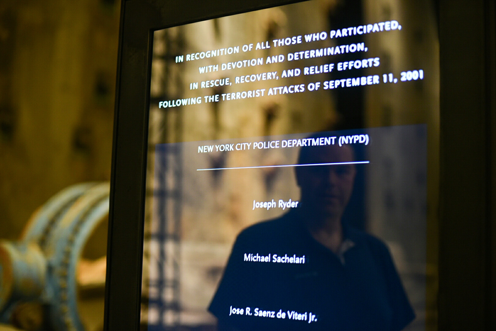 Retired NYPD Detective Joseph Ryder, my father, watches as his name scrolls by on the first responders board at the National September 11th Museum and Memorial in New York City on September 10, 2016. 