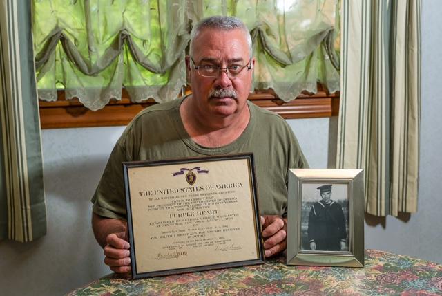 Ken Schultz, the nephew of Pearl Harbor casualty Kenneth Jayne, holds the Purple Heart his uncle was awarded posthumously in 1942.
