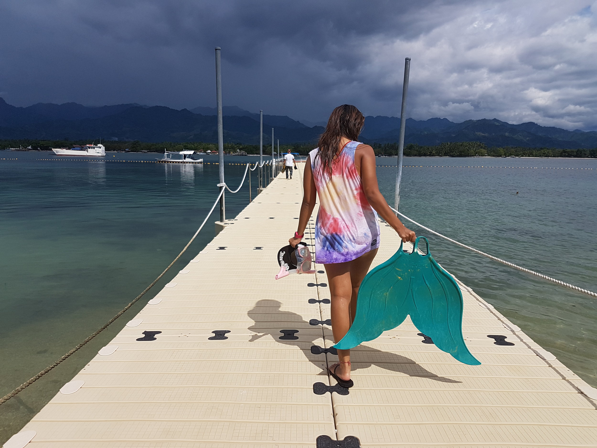 Running over to the other side of the jetty before the rain starts. *Shirt: Reefside Artworks | Location: Lubi Plantation, Kopiat Island | Photo by Mottie Santos*