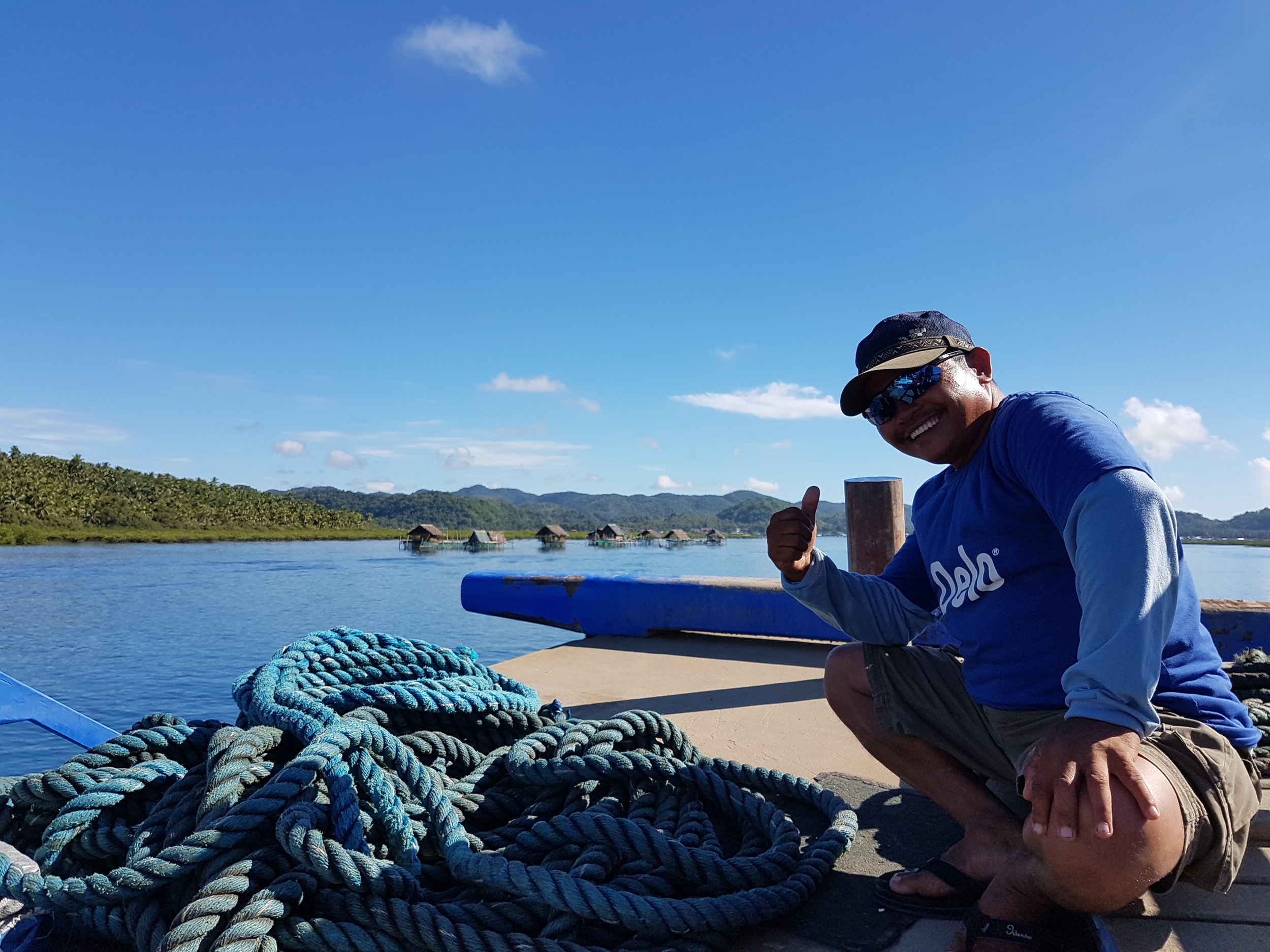 The friendliest crew member on the boat intentionally blocking my photo of Dapa Port and the fish cages around the Dapa Channel. Boatmen like him make a living ferrying people and cargo from Surigao to Siargao Island daily.