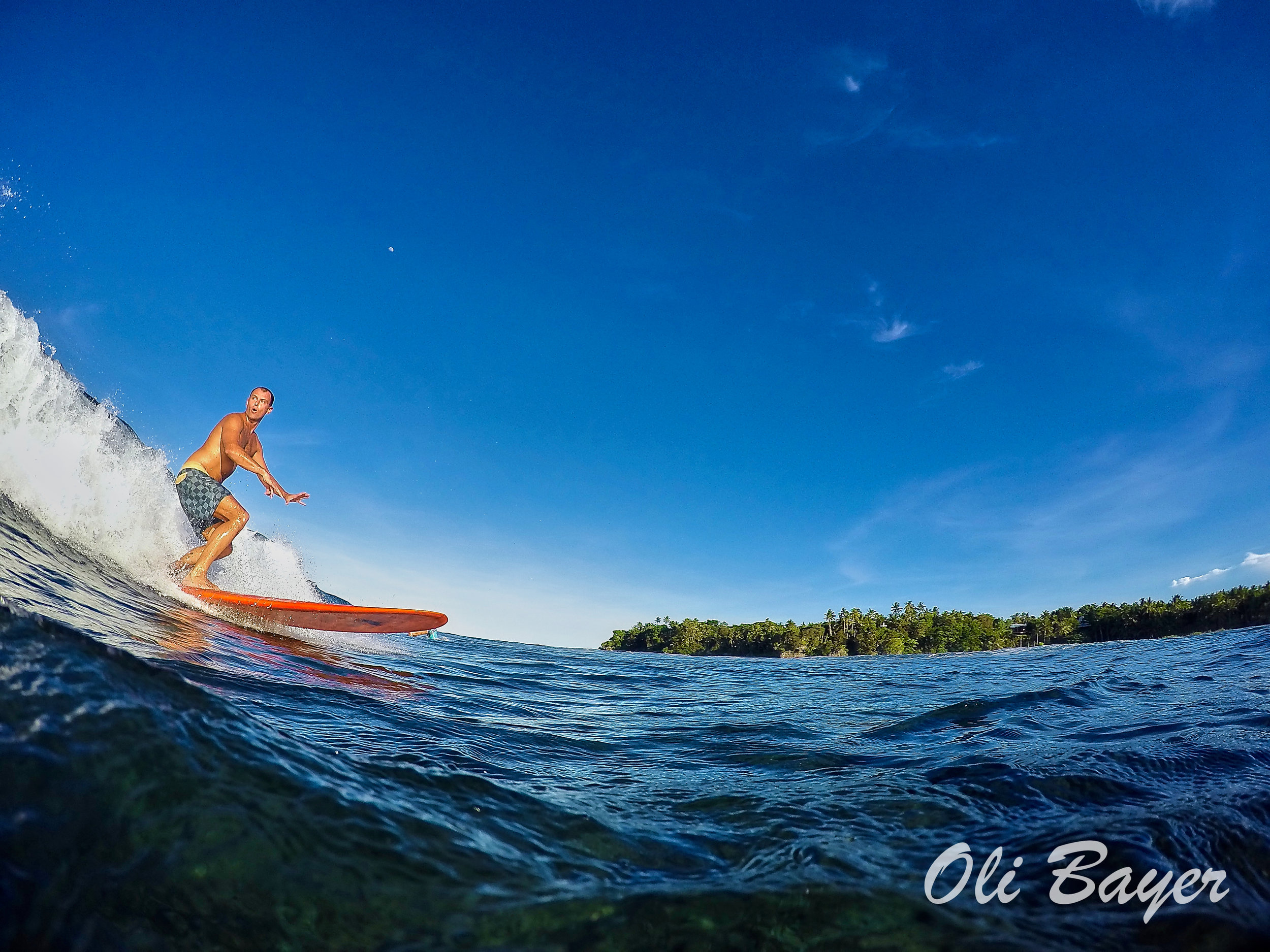 Clear blue skies and riding glassy waves make up the better part of living the island life in Siargao. Photo by Oli Bayer.