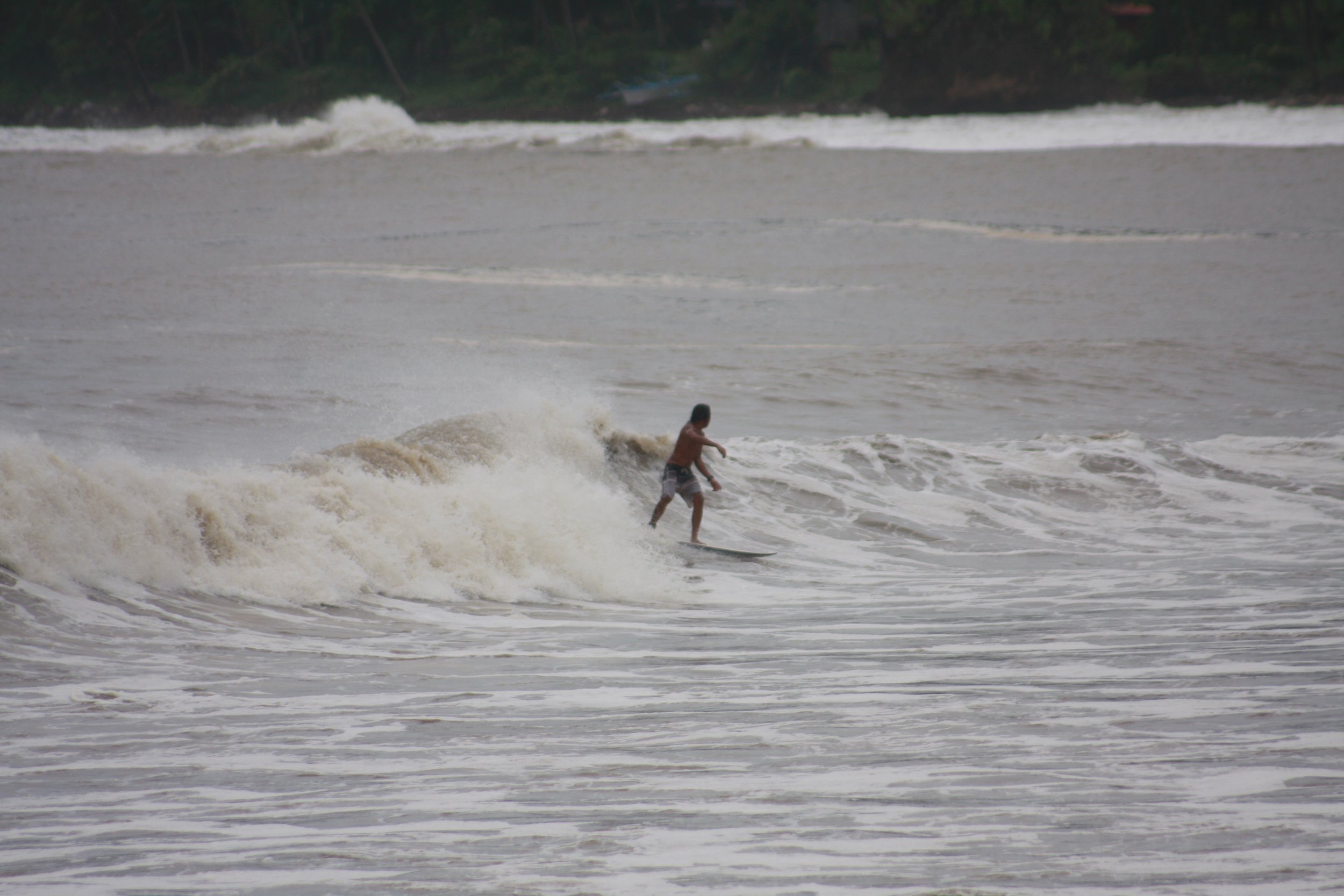 The only shortboarder in our crew, Sandy Santos, makes riding this shoulder-high wave look easy.
