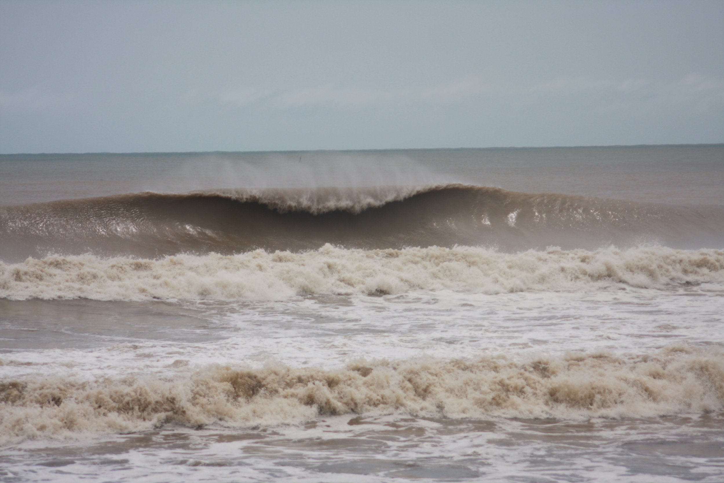 Despite the stormy weather, perfect A-frame waves can be still be seen. This is probably every surfer’s dream even with the muddy storm water.