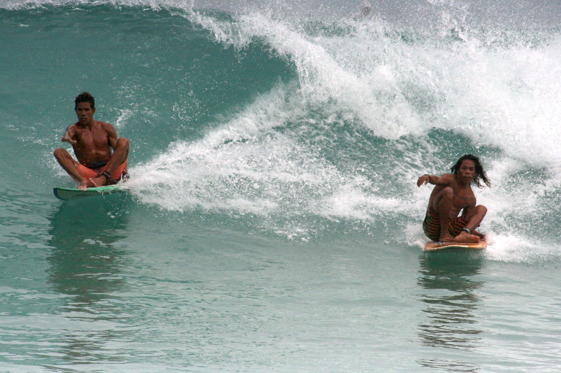 Locals just wanna have fun. Champion skimboarder Sonnyboy “Bayogyog” Aporbo (left) and Michael “Daggy” Bucong share a wave seated on their surf boards.
