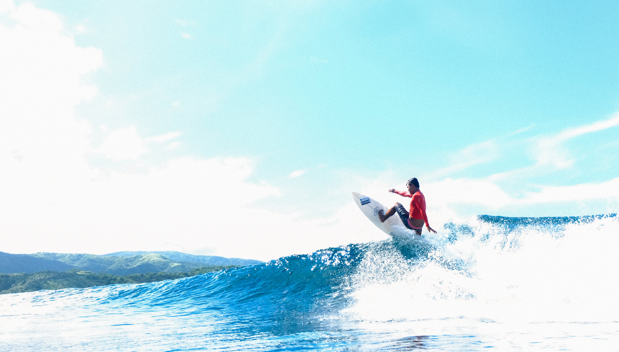 Surfer Martin Taniegra flies up the wave. Photo by Michael Eijansantos