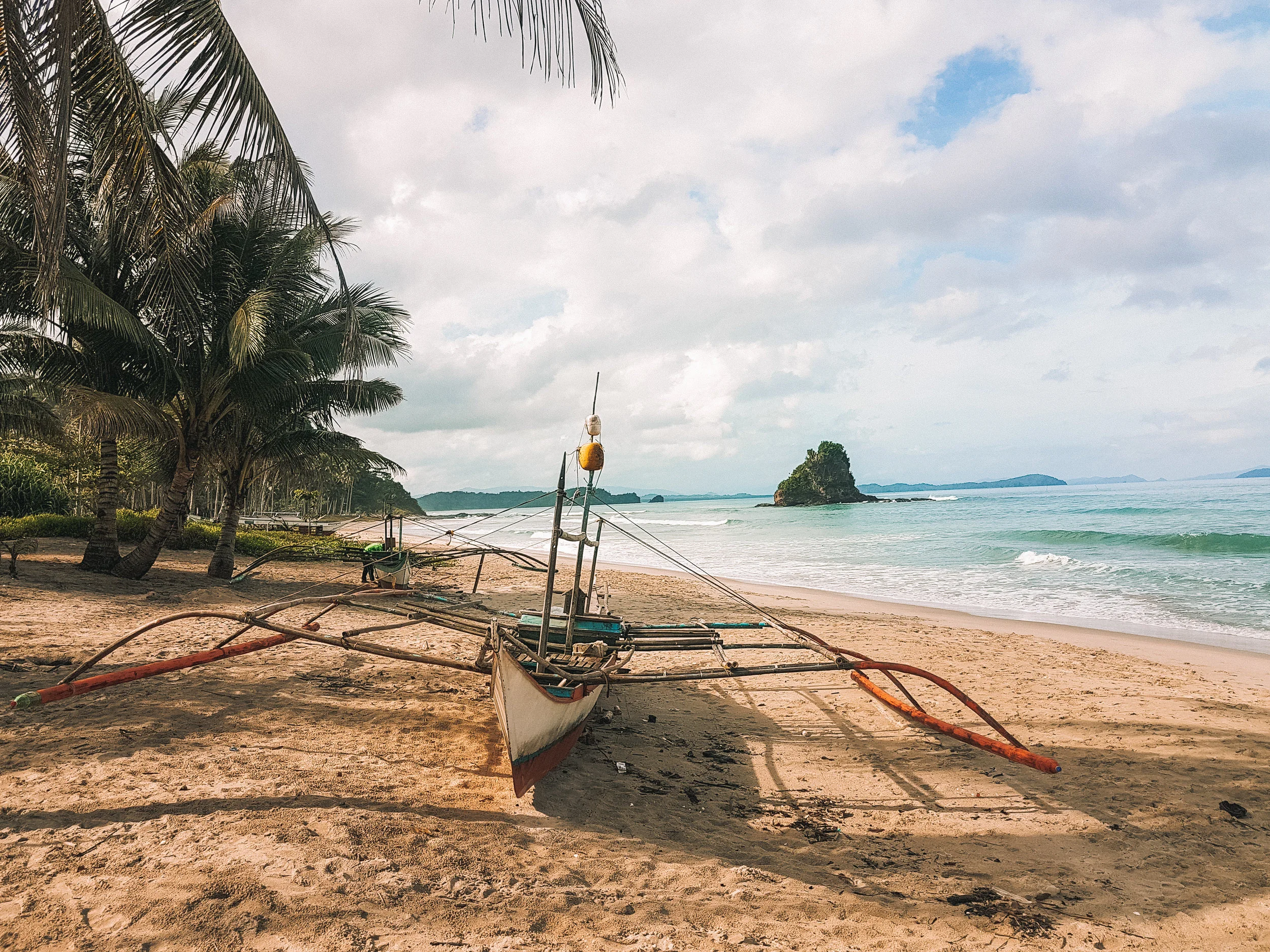 Alimanguan Beach, San Vicente's unmistakable tiny mound of rock where the surf spot is located nearby.