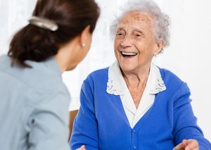 old lady smiling with carer.jpg